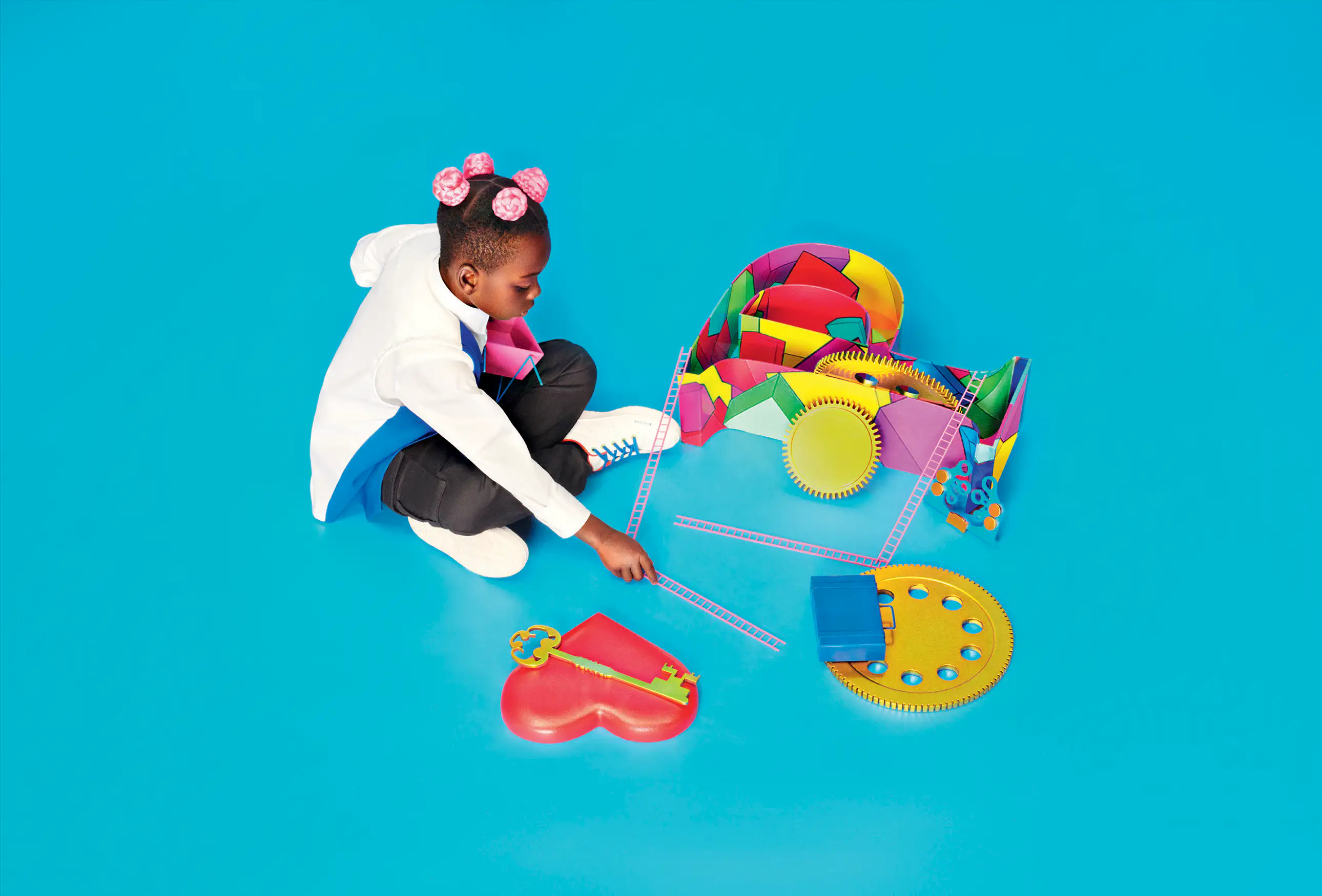Portrait of a child dressed as the Photographer Prince Gyasi playing with some elements that will be part of The Cal™ 2024 sets